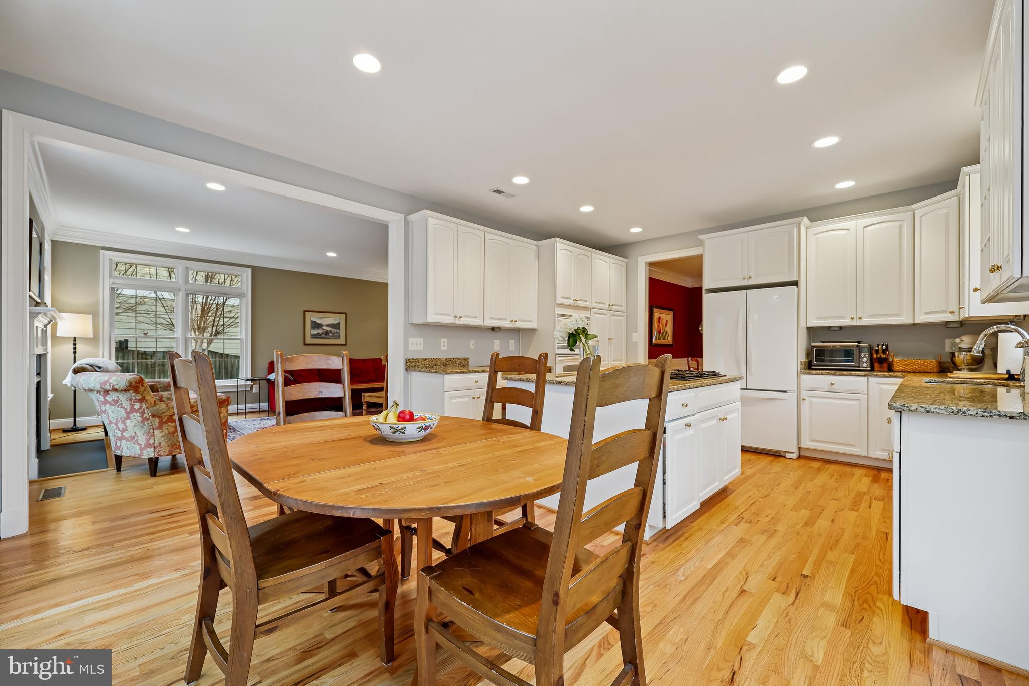 8807 Ridge Road Bethesda, MD 20817 - Photo 24 of 72 a kitchen with a dining table chairs stove refrigerator and cabinets