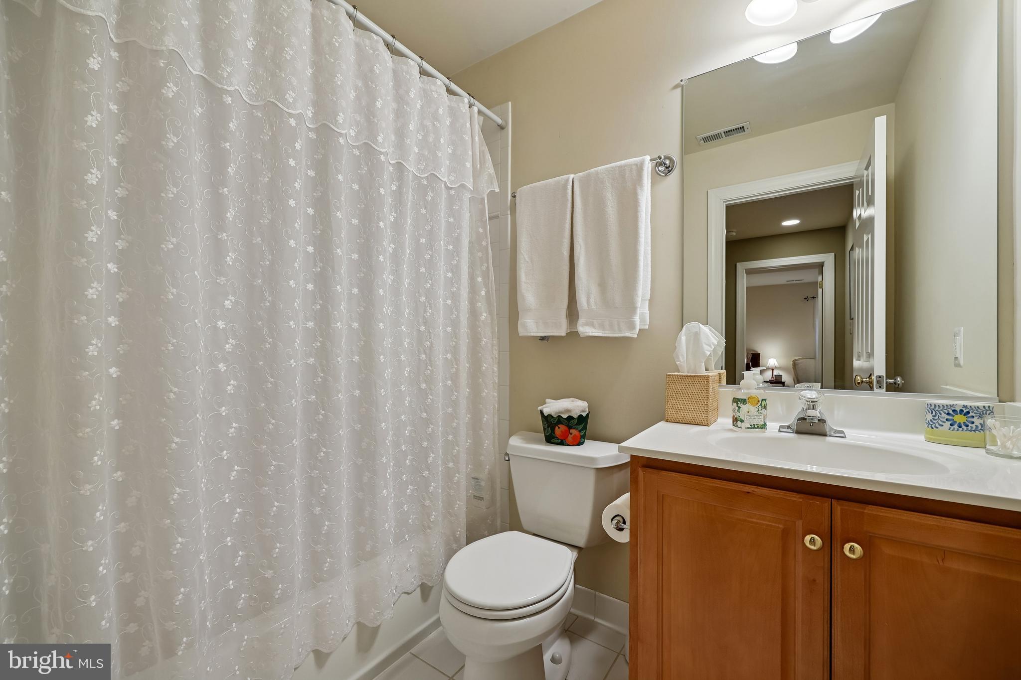 8807 Ridge Road Bethesda, MD 20817 - Photo 26 of 72 a bathroom with a toilet a sink and a mirror