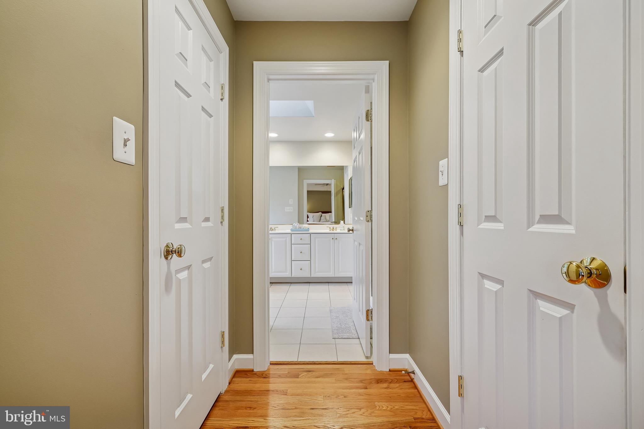 8807 Ridge Road Bethesda, MD 20817 - Photo 31 of 72 a view of a hallway with wooden floor and a bathroom
