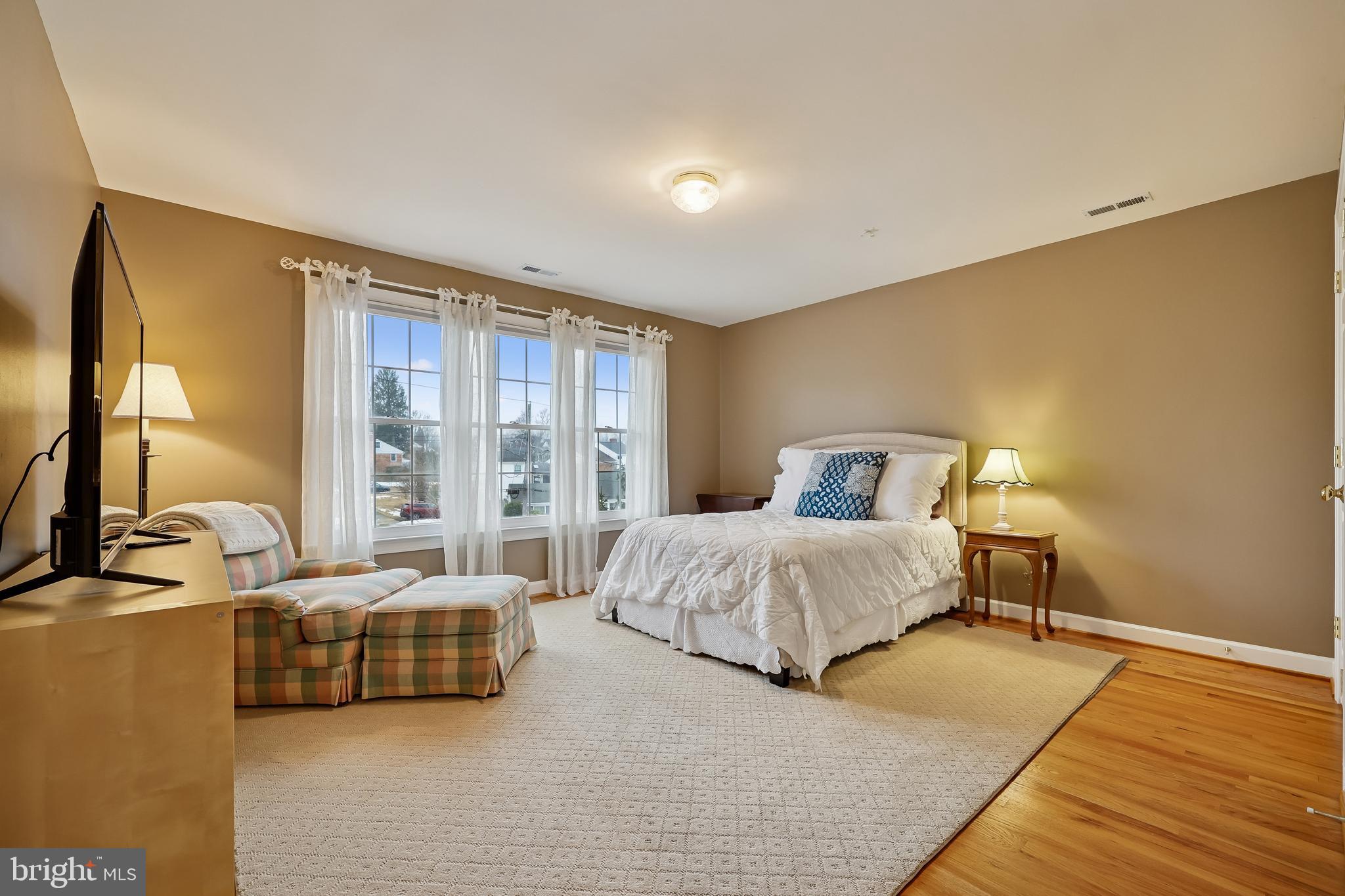 8807 Ridge Road Bethesda, MD 20817 - Photo 40 of 72 a spacious bedroom with a bed and a large window