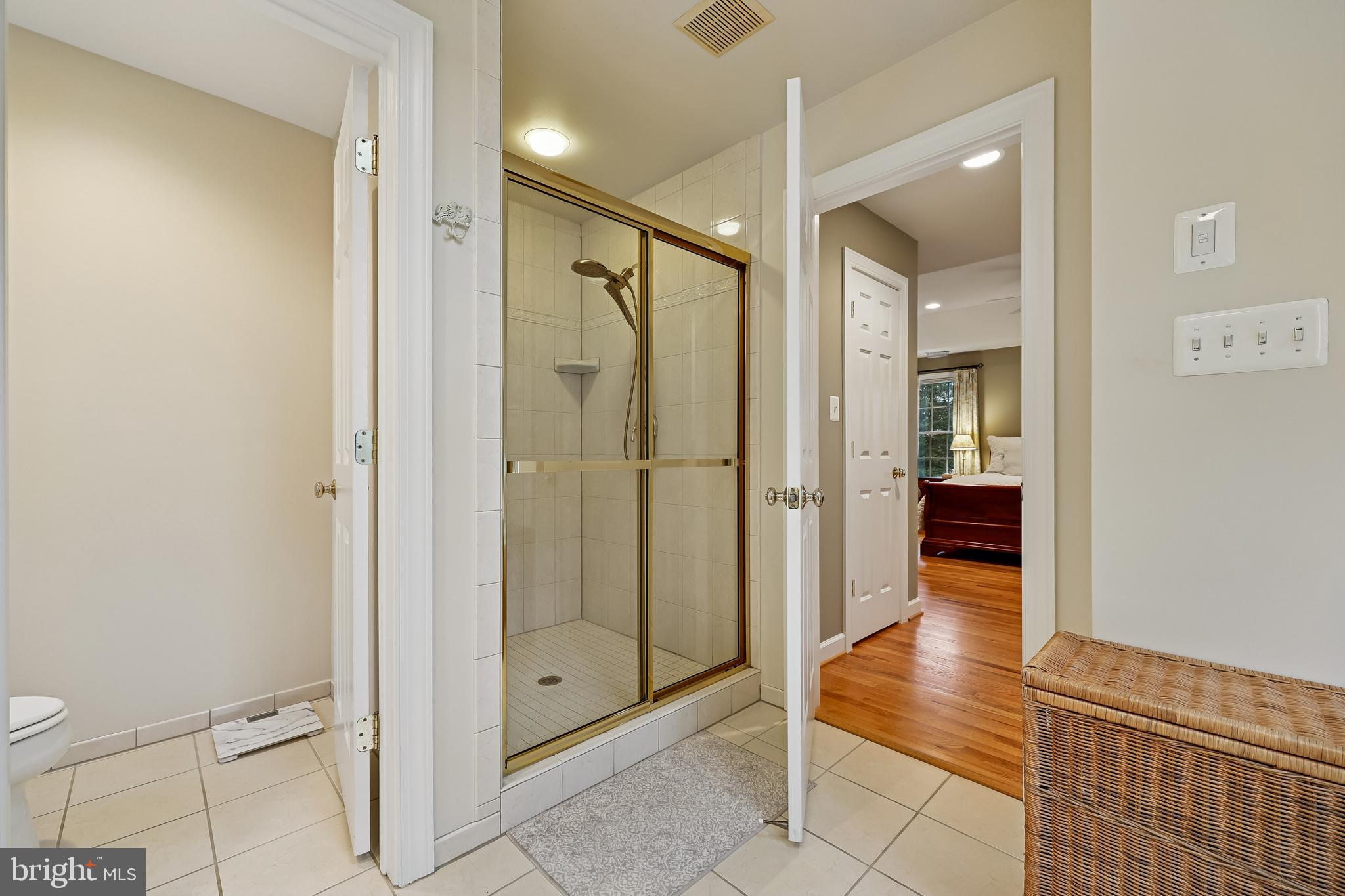 8807 Ridge Road Bethesda, MD 20817 - Photo 66 of 72 a bathroom with a glass shower door