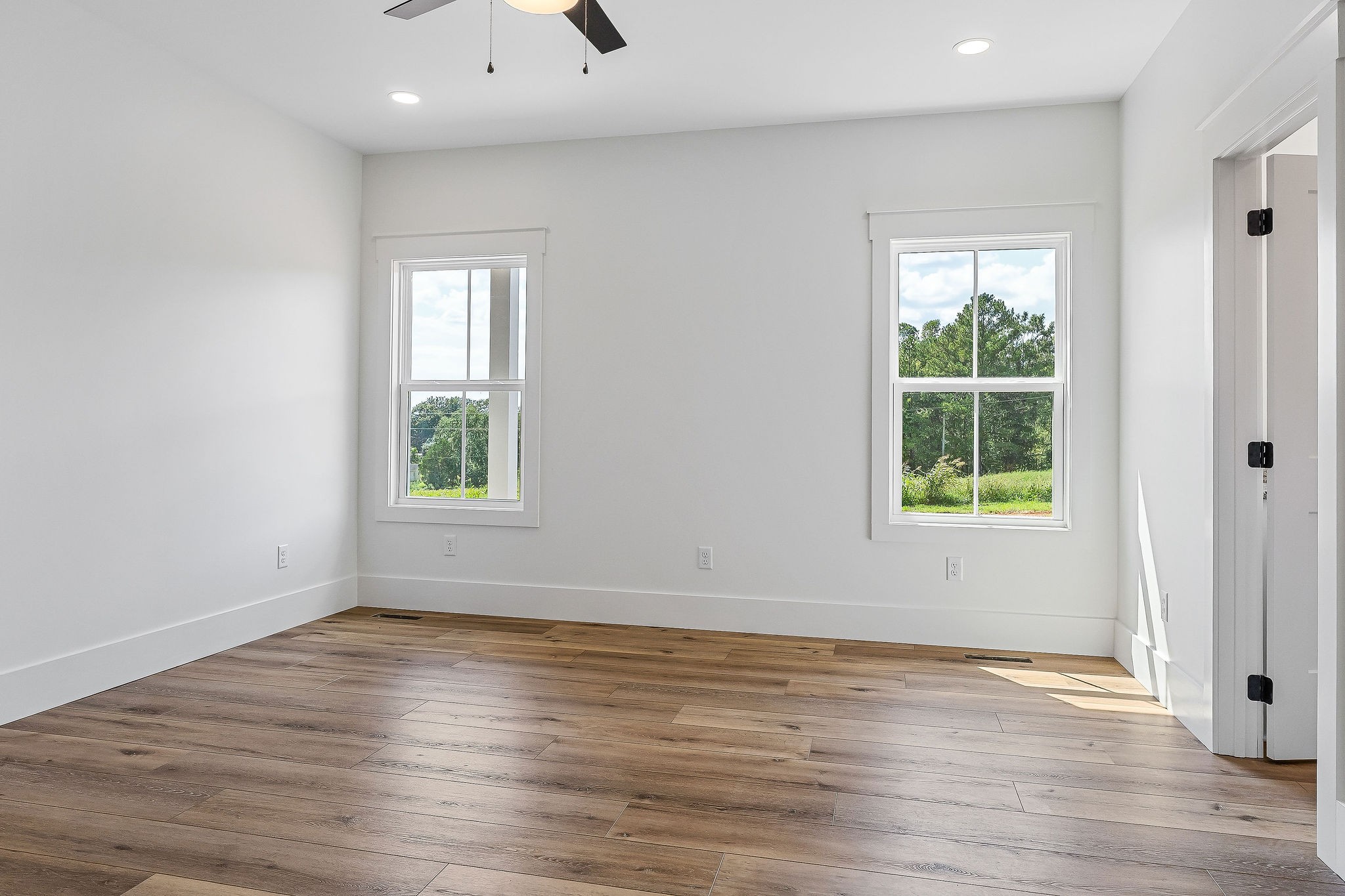 612 Harleys Ridge Road Sparta, TN 38583 - Photo 12 of 32 an empty room with wooden floor and windows