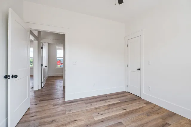 a view of a hallway with wooden floor