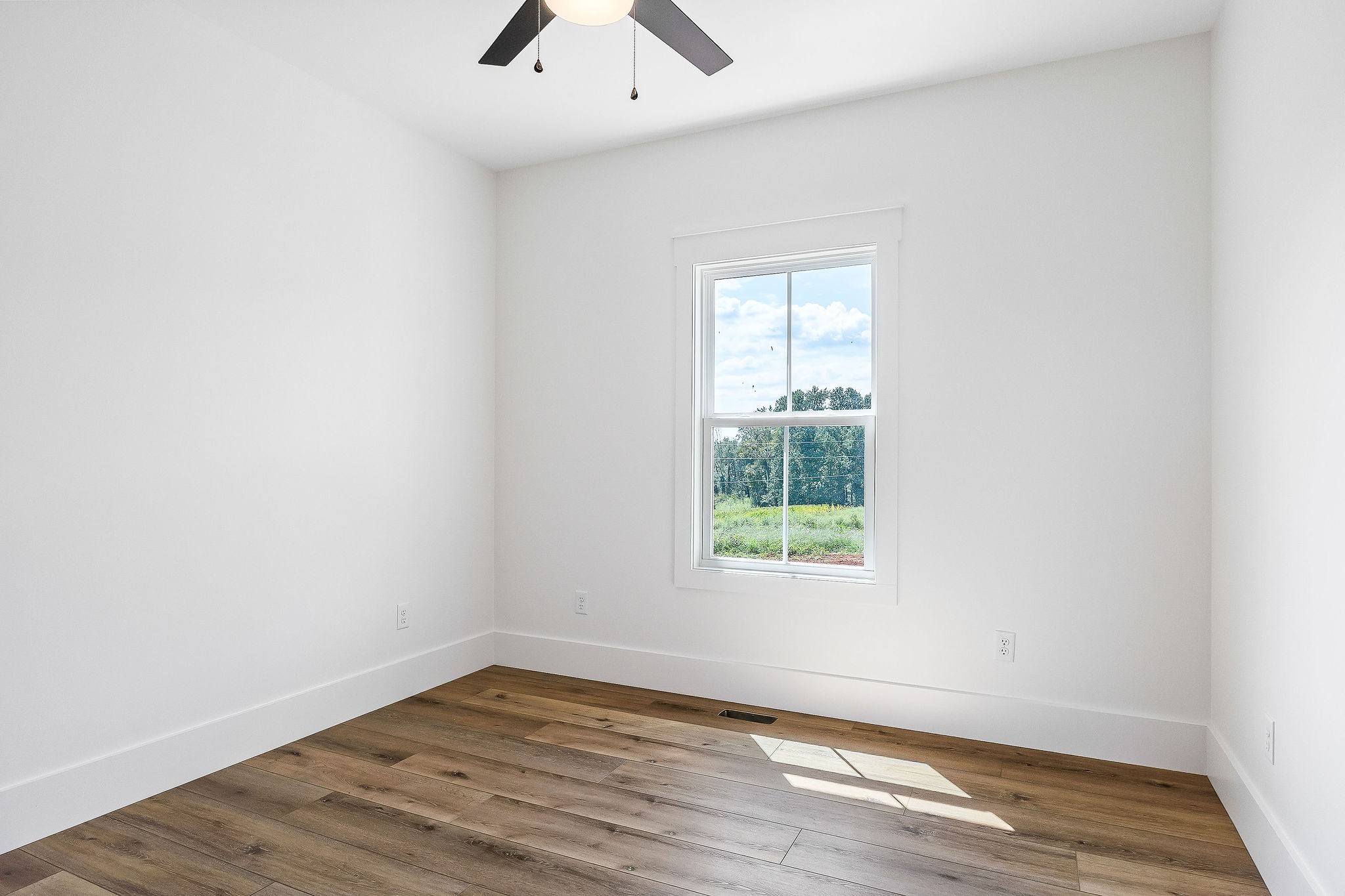 612 Harleys Ridge Road Sparta, TN 38583 - Photo 24 of 32 an empty room with wooden floor and windows