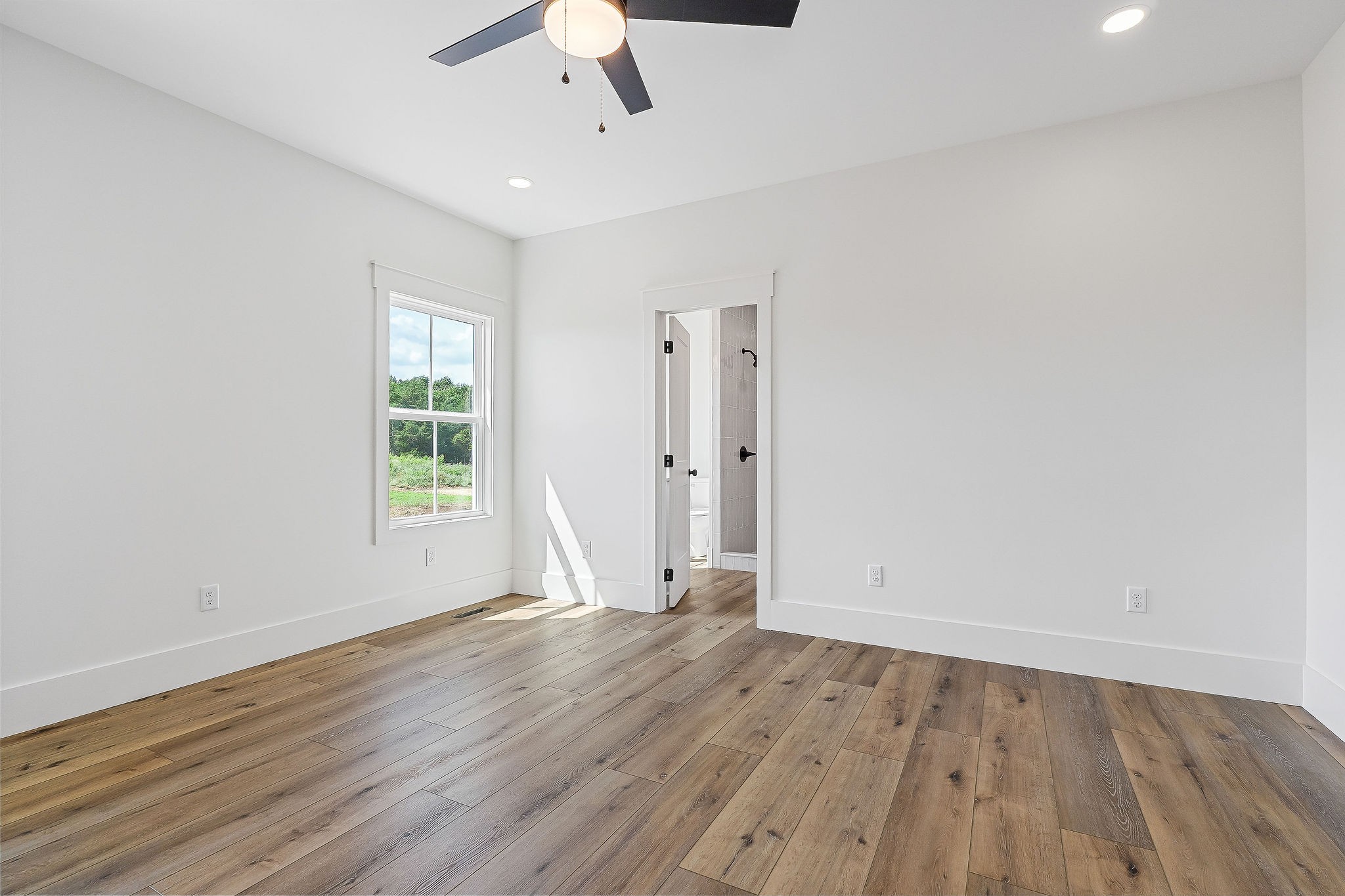612 Harleys Ridge Road Sparta, TN 38583 - Photo 25 of 32 an empty room with wooden floor and windows