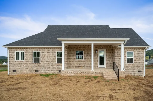 a house that has a tree in front of it