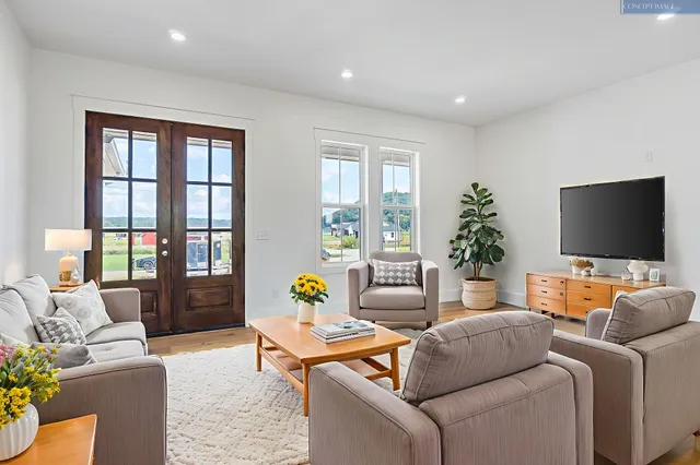 a living room with furniture and a flat screen tv