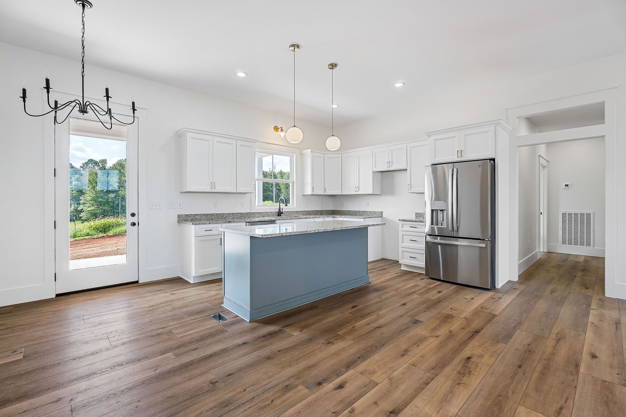 612 Harleys Ridge Road Sparta, TN 38583 - Photo 7 of 32 a kitchen with stainless steel appliances granite countertop a refrigerator a sink dishwasher a stove and white countertops with wooden floor