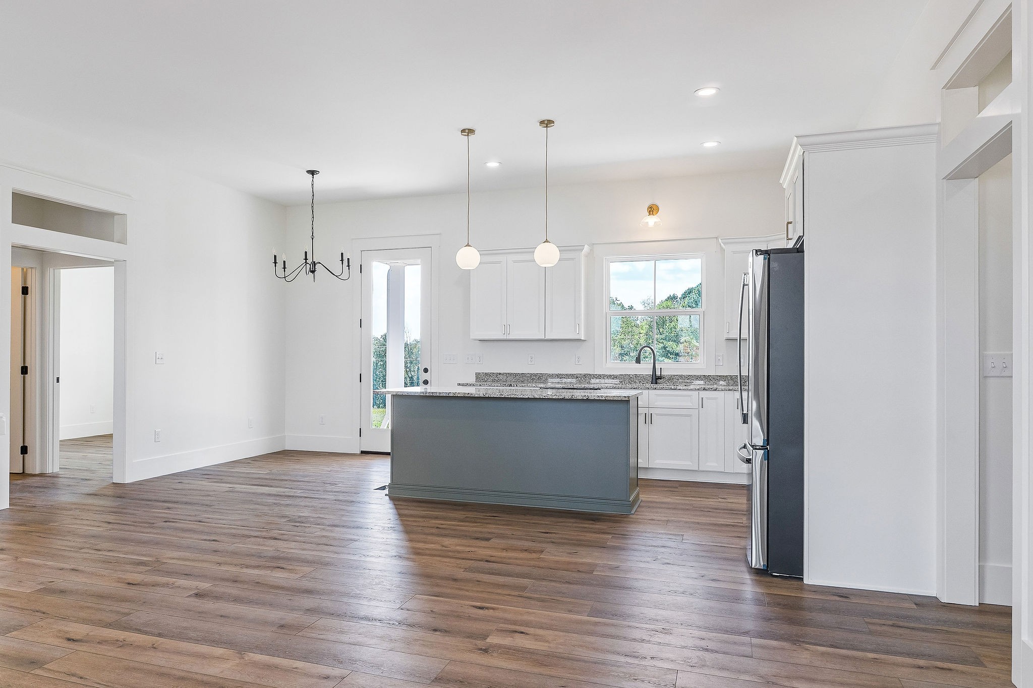 612 Harleys Ridge Road Sparta, TN 38583 - Photo 10 of 32 a large kitchen with a wooden floor and a refrigerator