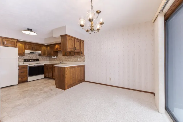 a view of kitchen with granite countertop cabinets and stainless steel appliances
