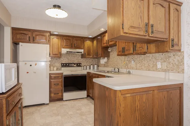 a kitchen with stainless steel appliances granite countertop a sink stove and cabinets