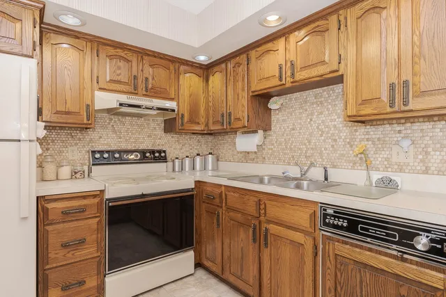 a kitchen with sink cabinets and window