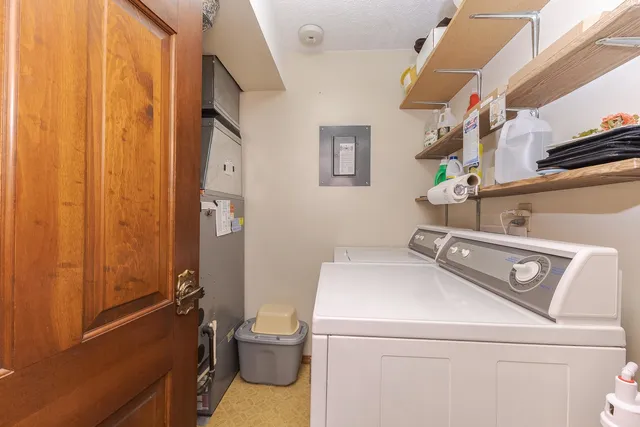 a spacious bedroom with a bed and a dresser