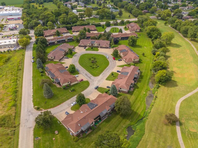 an aerial view of a house with garden space and a street view
