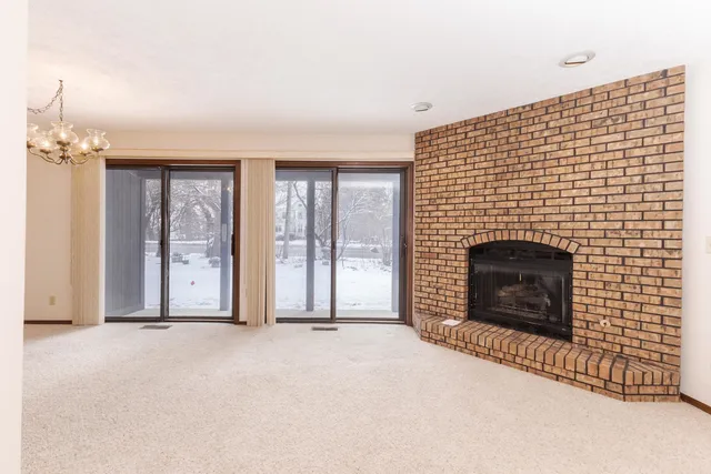 a view of an empty room with a fireplace