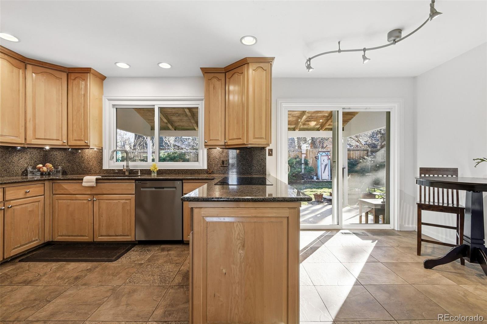 3561 South Oneida Way Denver, CO 80237 - Photo 14 of 48 a kitchen with stainless steel appliances granite countertop a stove a sink and a refrigerator