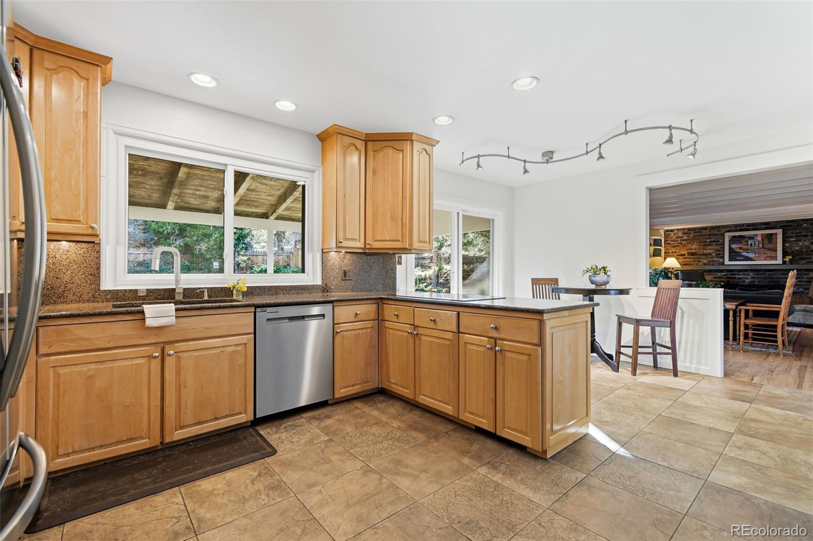 3561 South Oneida Way Denver, CO 80237 - Photo 15 of 48 a kitchen with stainless steel appliances granite countertop sink window and cabinets