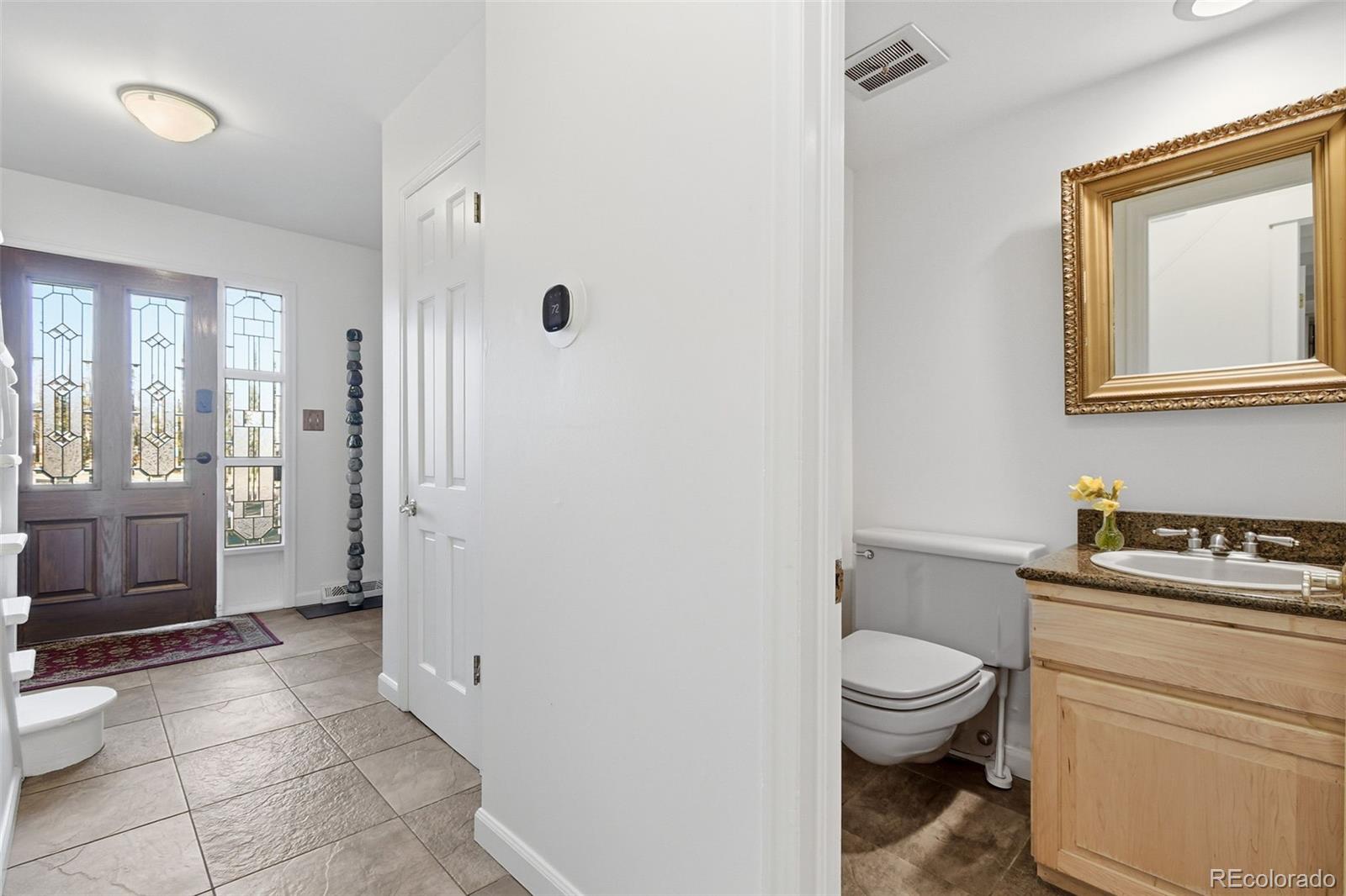 3561 South Oneida Way Denver, CO 80237 - Photo 17 of 48 a bathroom with a toilet sink and a shower