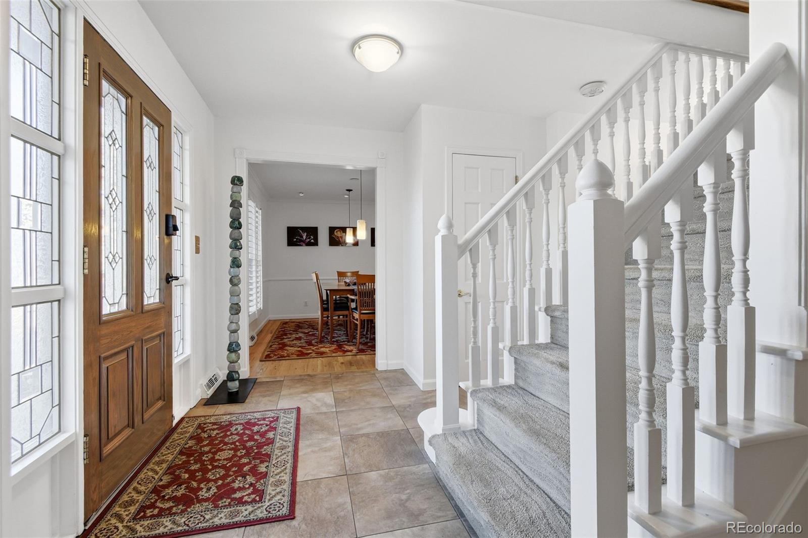 3561 South Oneida Way Denver, CO 80237 - Photo 2 of 48 a hallway with wooden floor and furniture
