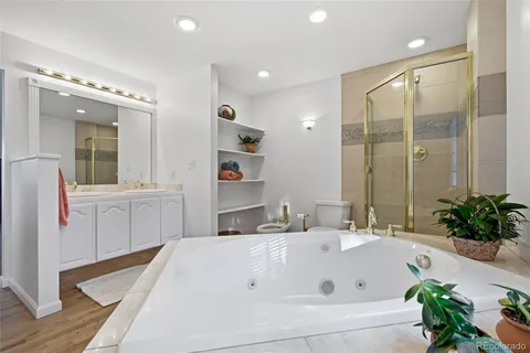 a bathroom with a tub sink and mirror