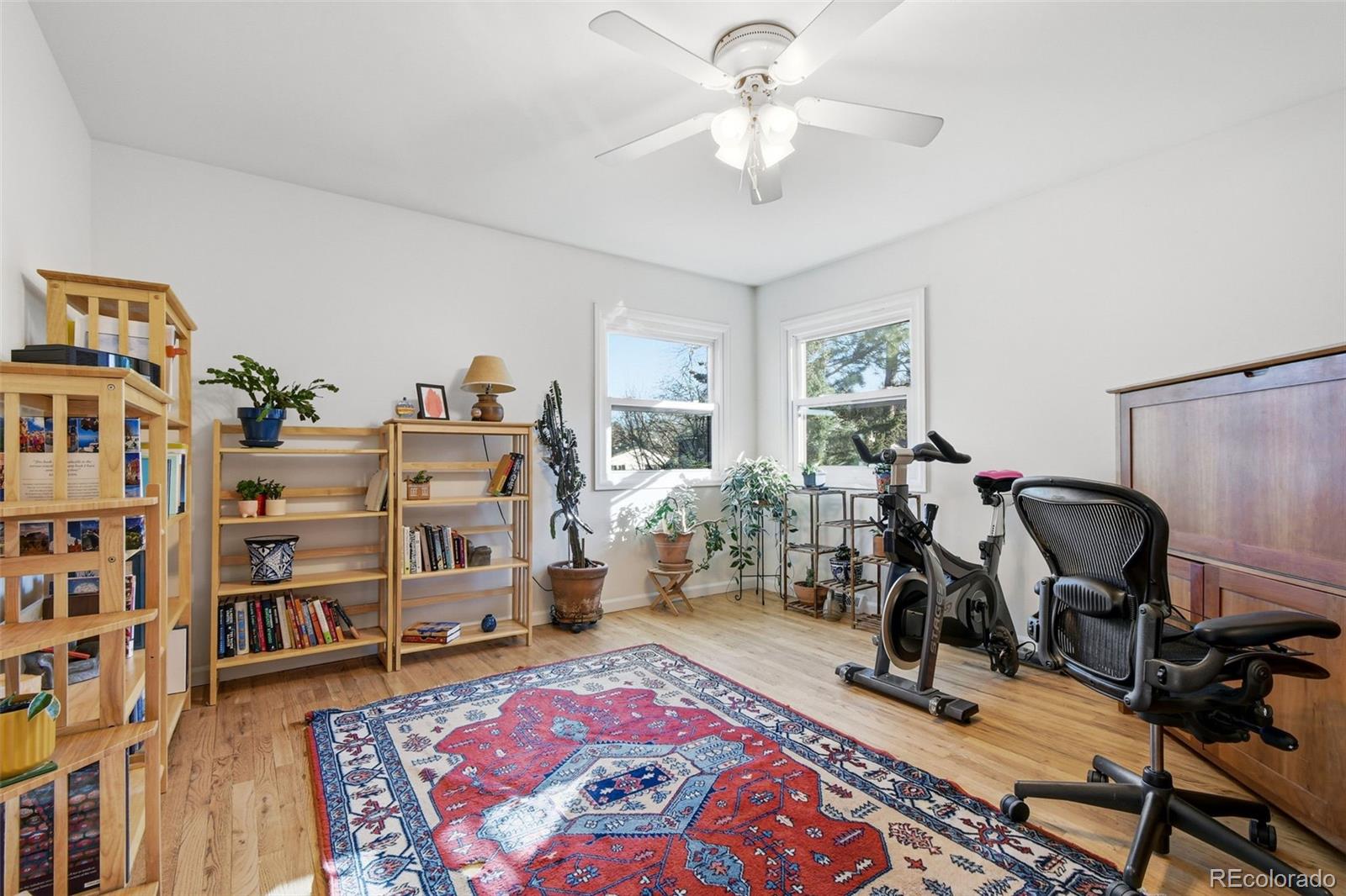 3561 South Oneida Way Denver, CO 80237 - Photo 26 of 48 a bed room with a bed and a book shelf
