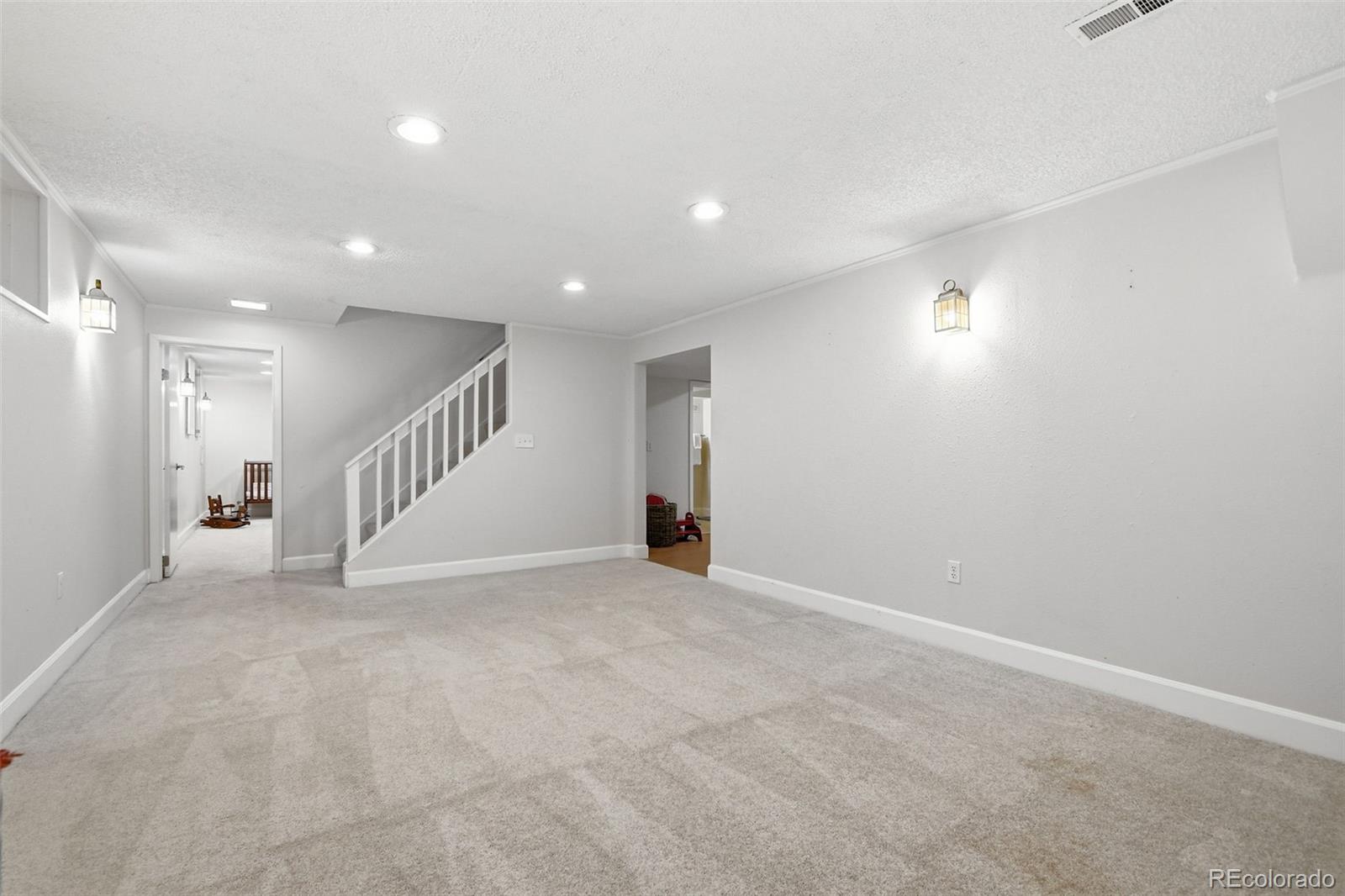 3561 South Oneida Way Denver, CO 80237 - Photo 28 of 48 a view of an empty room with stairs