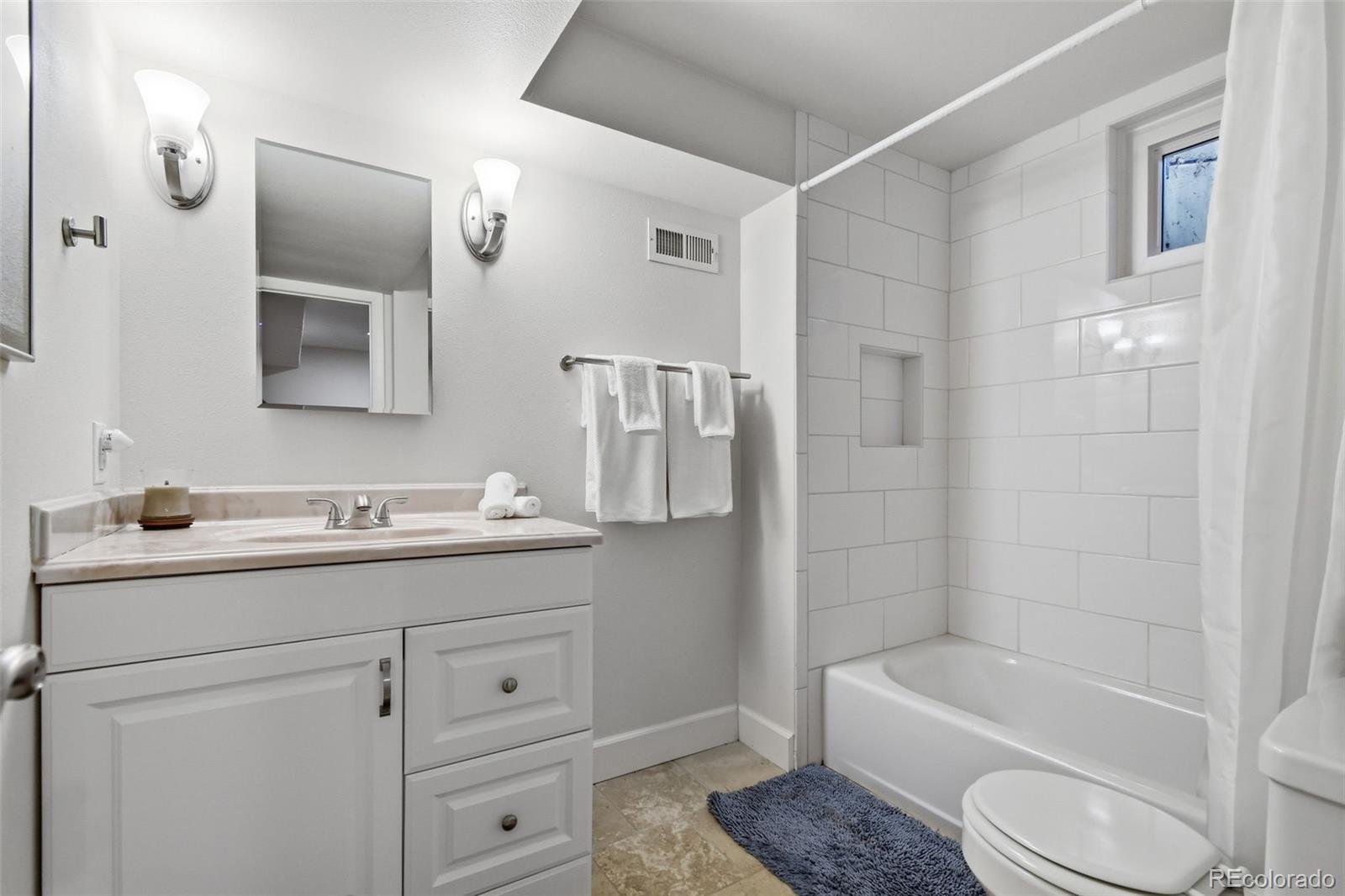 3561 South Oneida Way Denver, CO 80237 - Photo 29 of 48 a bathroom with a granite countertop sink toilet and shower