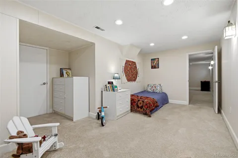 a bedroom with a bed and a painting on the wall