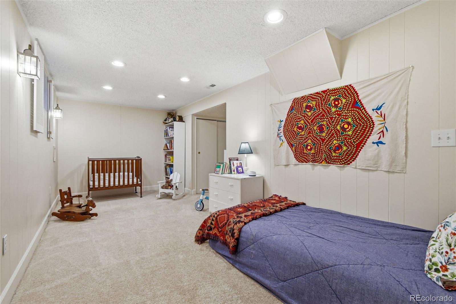 3561 South Oneida Way Denver, CO 80237 - Photo 32 of 48 a bedroom with a bed and a painting on the wall