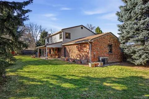 a view of house with backyard