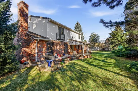 a view of a house with a yard and potted plants