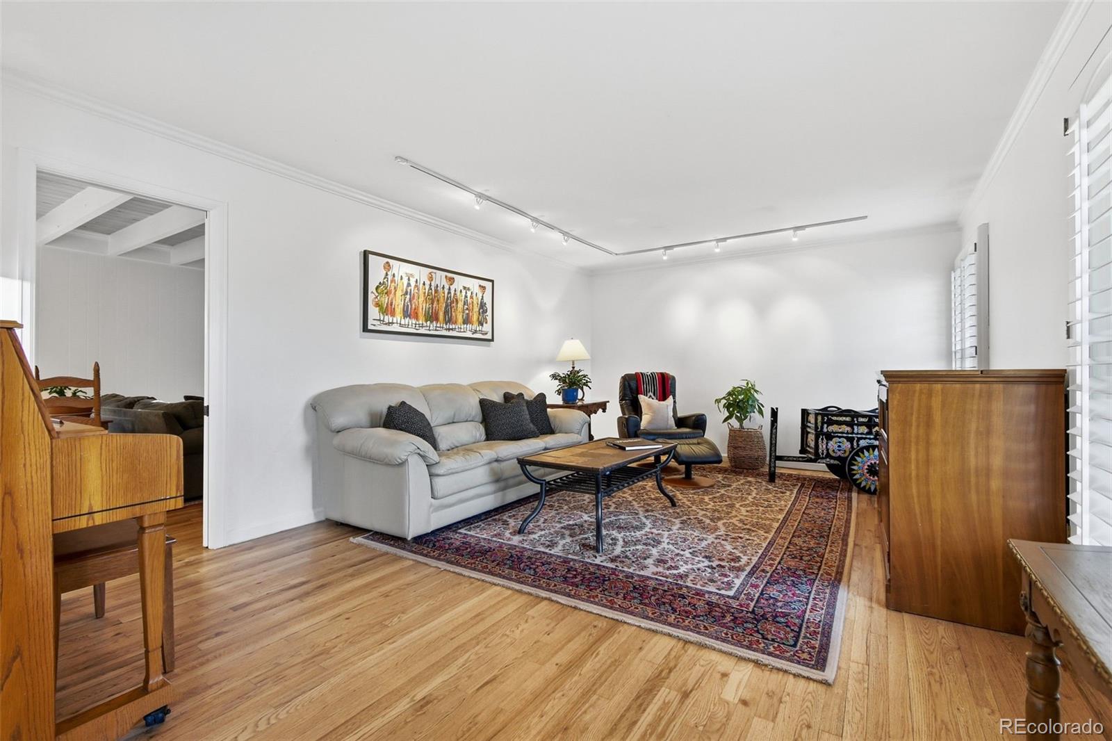 3561 South Oneida Way Denver, CO 80237 - Photo 5 of 48 a living room with furniture and wooden floor