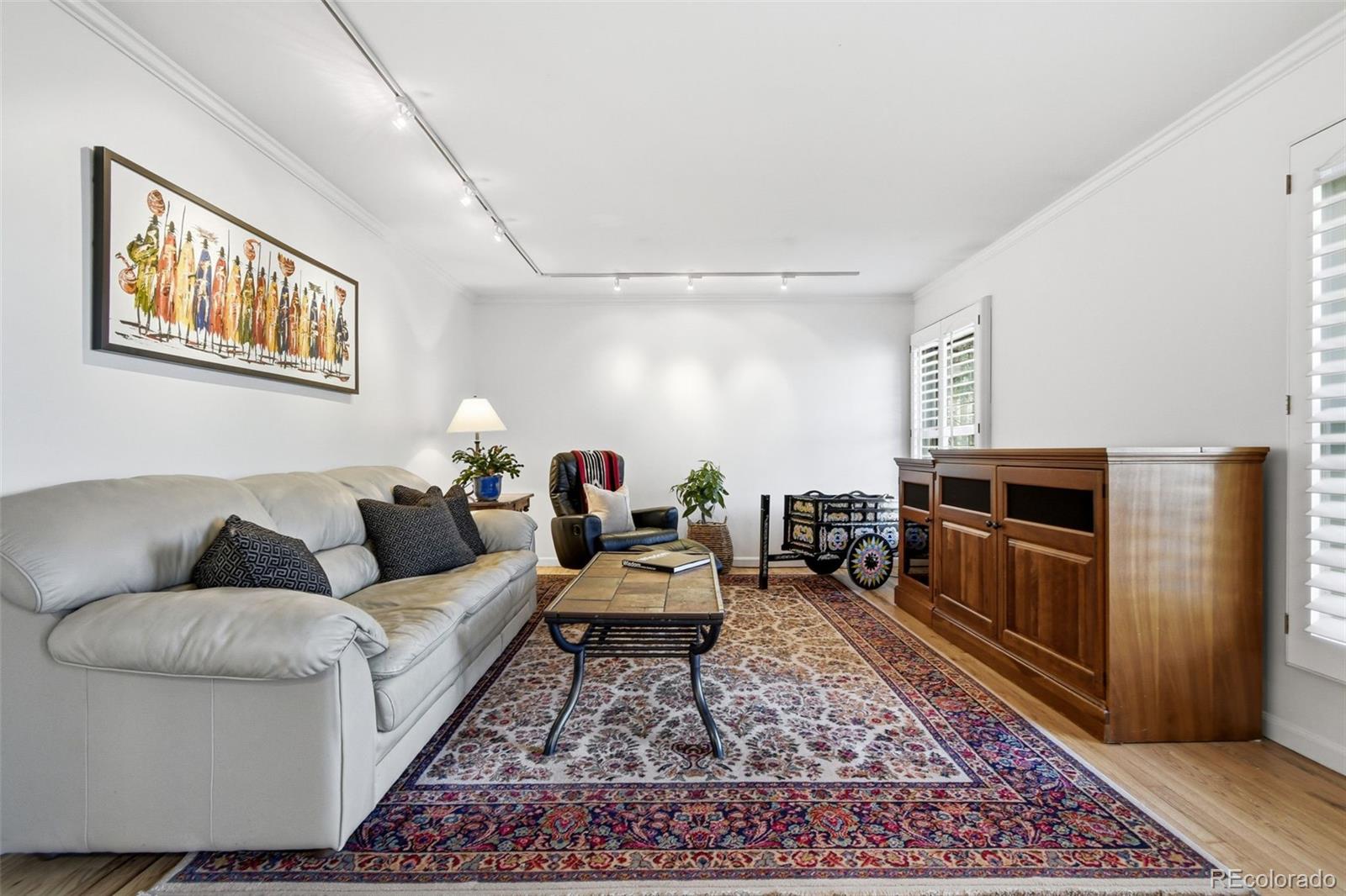 3561 South Oneida Way Denver, CO 80237 - Photo 6 of 48 a living room with furniture and a rug