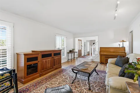 a living room with furniture and a dresser