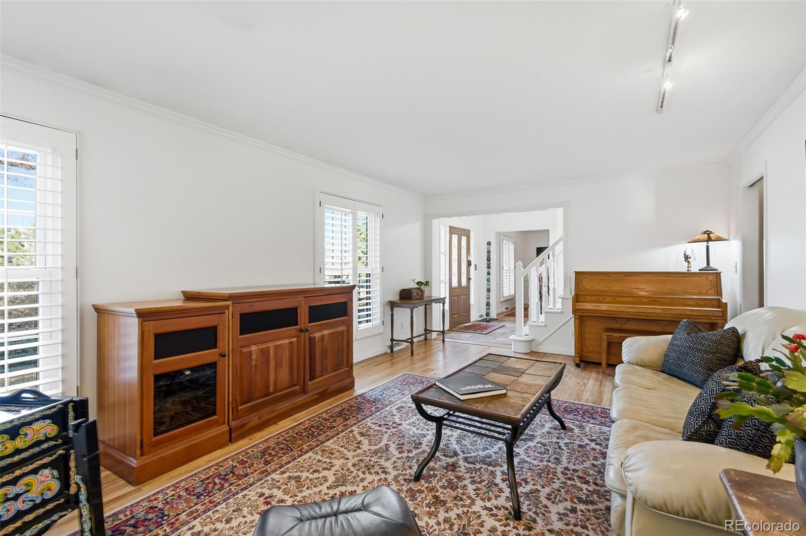 3561 South Oneida Way Denver, CO 80237 - Photo 7 of 48 a living room with furniture and a dresser