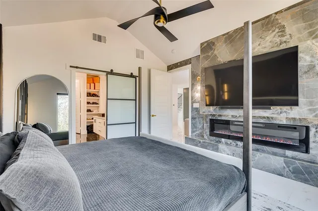 a large white kitchen with a granite countertop sink and a mirror