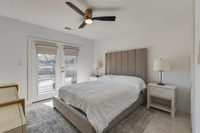 a living room with a table chairs and a kitchen