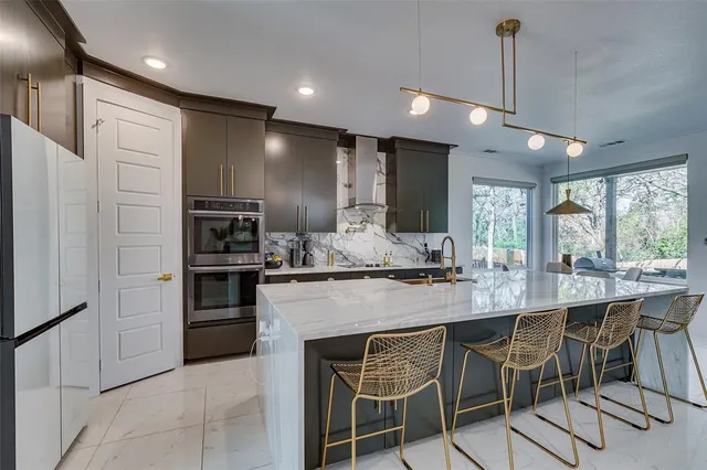 a kitchen with granite countertop a table and chairs in it