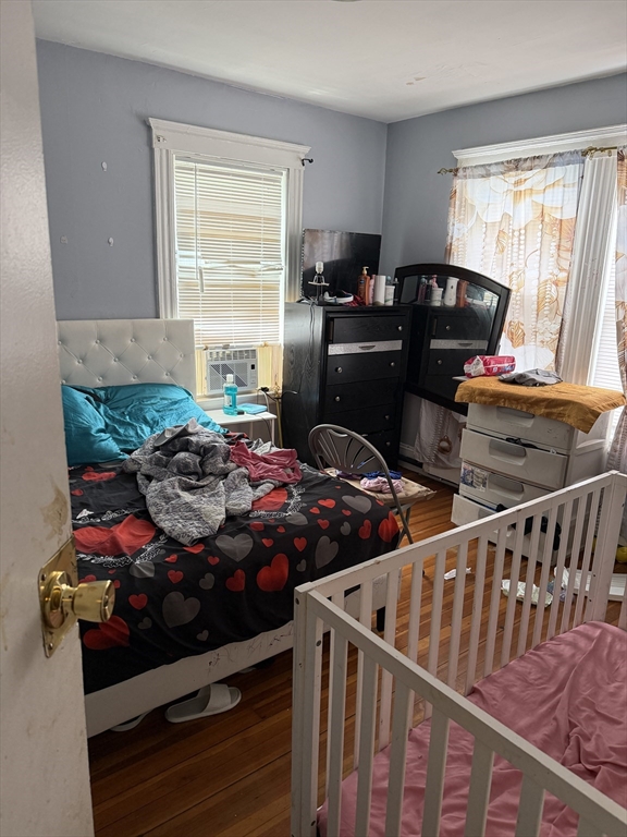 8 Ogden Street Boston, MA 02124 - Photo 15 of 20 a bedroom with two beds and wooden floor