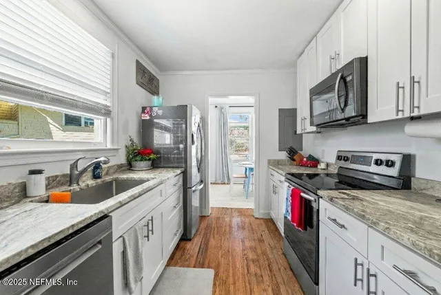 a bathroom with a sink a toilet and a window