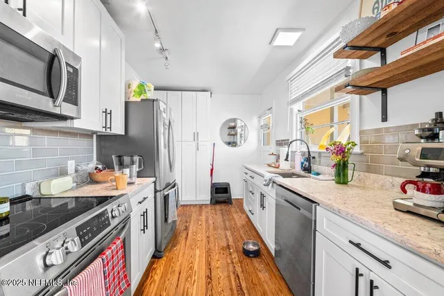 a open kitchen with granite countertop lots of counter top space