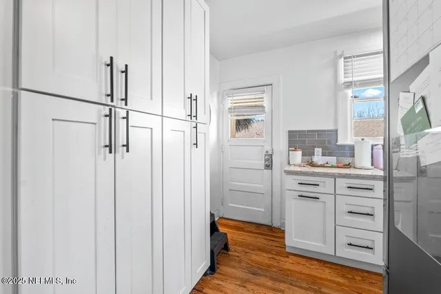 a bedroom with a bed window and flat screen tv