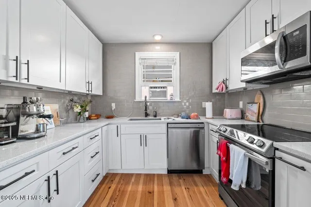 a kitchen with a sink cabinets and window