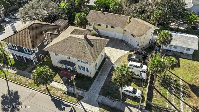 an aerial view of a house with garden space and street view