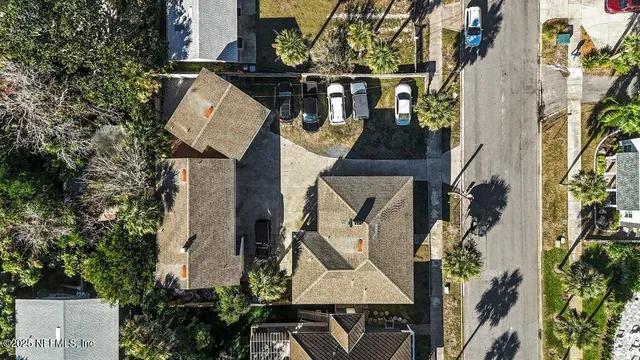 an aerial view of a house with street