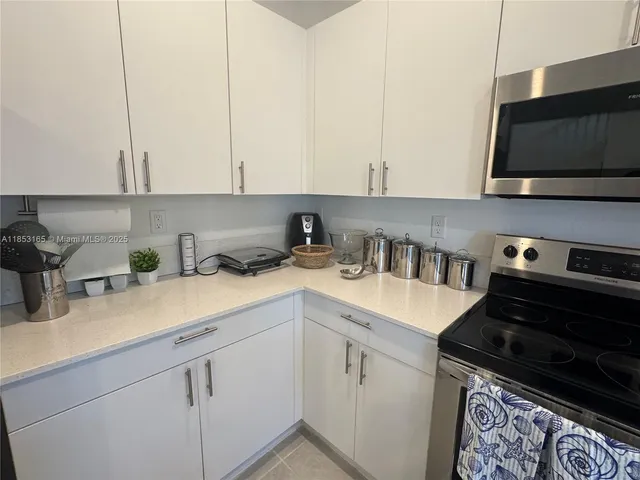 a kitchen with a refrigerator and cabinets