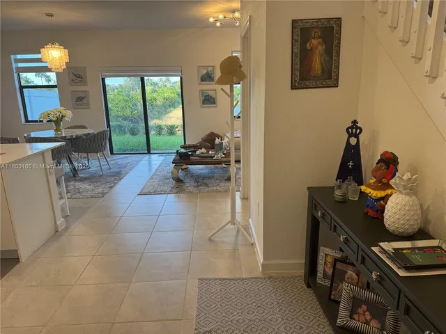 a kitchen with stainless steel appliances a refrigerator and a view of living room