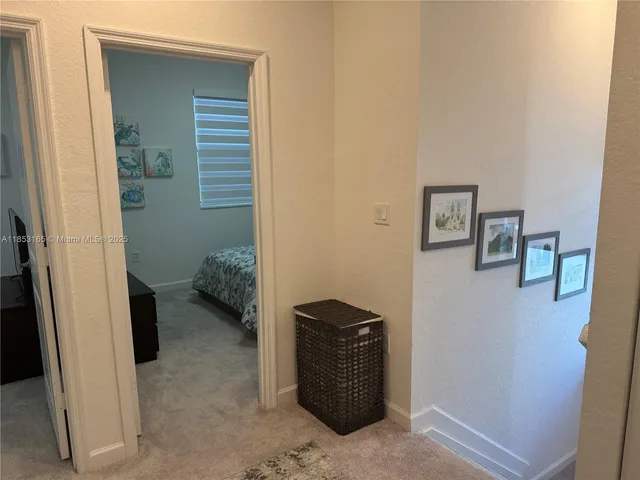 a bedroom with a bed and a painting on the wall