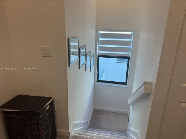 a bedroom with a bed and painting on the wall