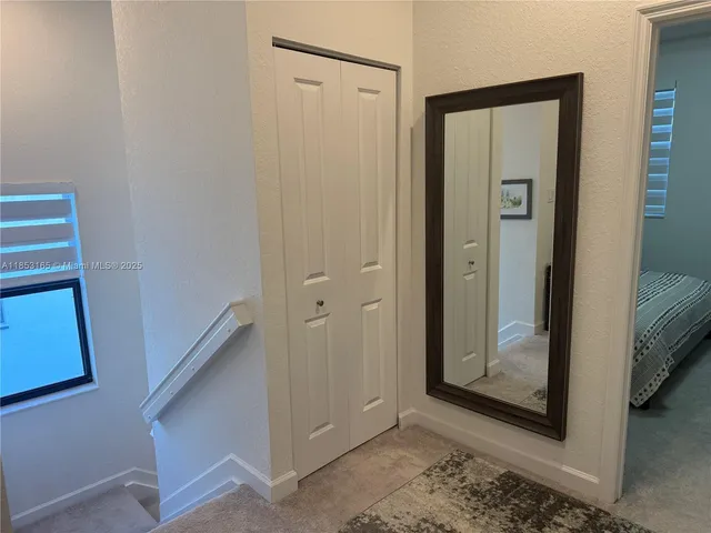 a bed sitting in a bedroom next to a window